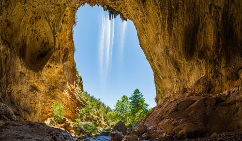 Low angle view of rock formation against sky