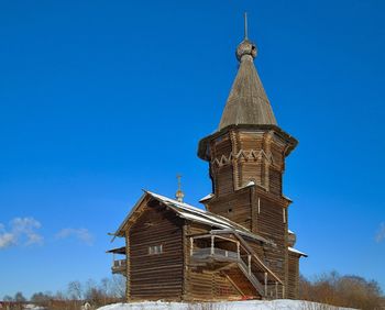 Low angle view of old church against blue sky