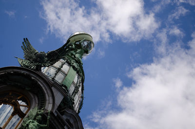 Low angle view of statue against cloudy sky