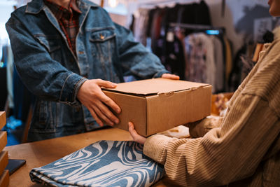 Midsection of man holding gift box