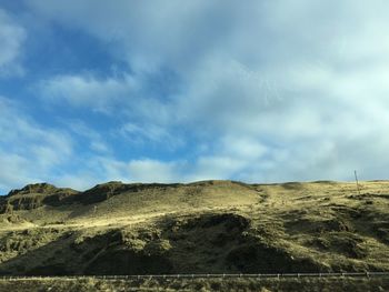 Scenic view of landscape against cloudy sky