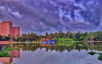 Scenic view of lake and buildings against sky