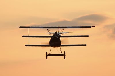 Silhouette airplane against sky during sunset
