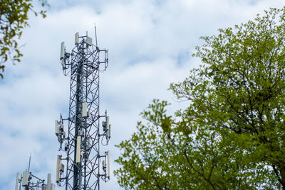 Low angle view of communications tower against sky