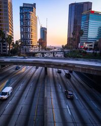 Vehicles on road in city against clear sky