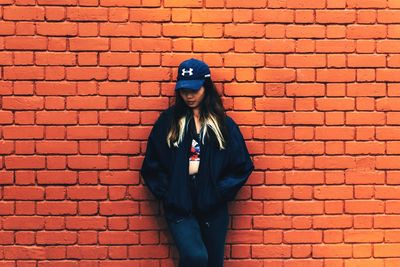 Person sitting on brick wall