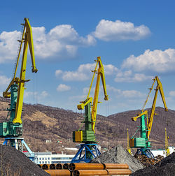 Low angle view of crane against sky