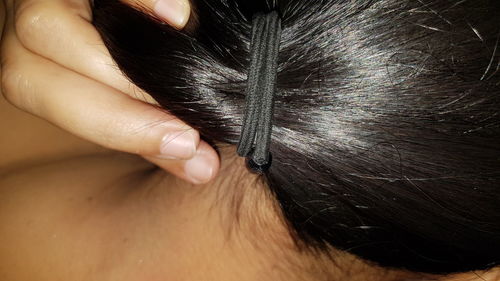 Close-up of woman with hand in hair