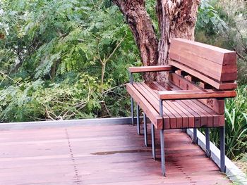 Empty chairs and table against trees