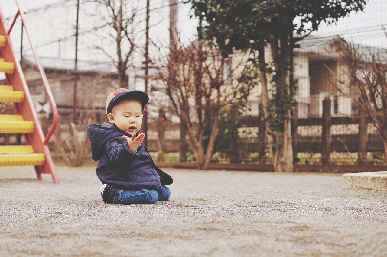 playground, childhood, full length, one person, males, park - man made space, swing, outdoor play equipment, autumn, outdoors, portrait, warm clothing, people, happiness, children only, schoolyard, nature, day