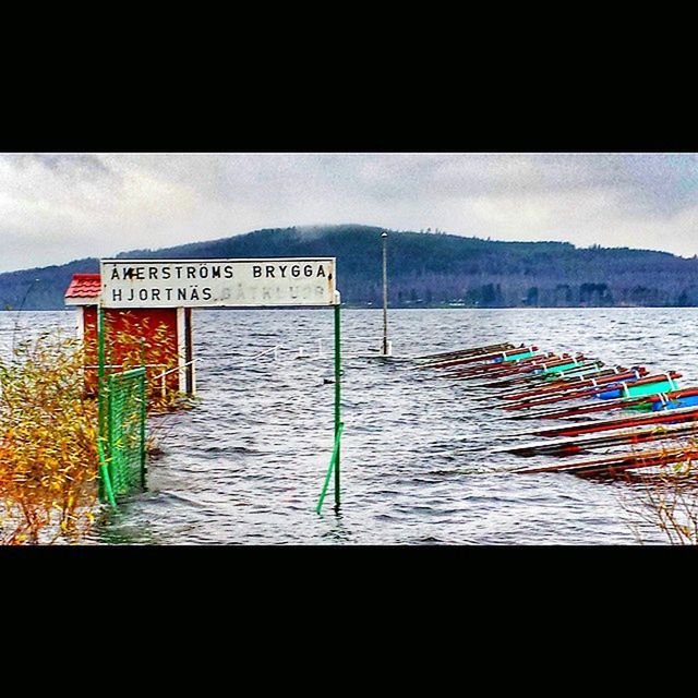 text, western script, communication, water, sky, information sign, sign, non-western script, auto post production filter, built structure, sea, transfer print, the way forward, day, outdoors, no people, railing, nature, guidance, tranquility