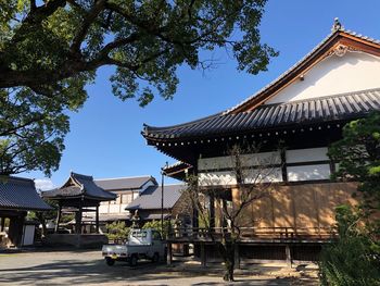 Exterior of house by building against sky