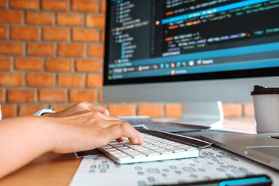 Midsection of person using laptop on table