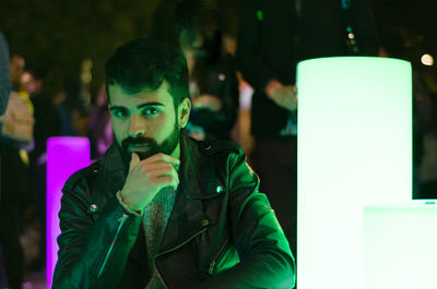 Portrait of bearded young man wearing leather jacket in nightclub