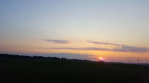 Scenic view of field against sky during sunset