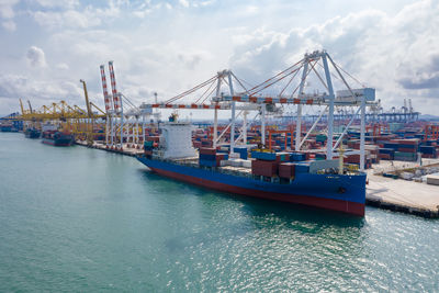 Ship moored at harbor against sky