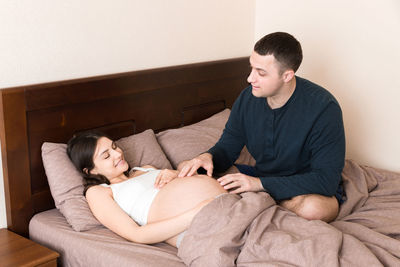 Young couple lying on bed