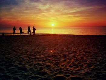 People on beach at sunset