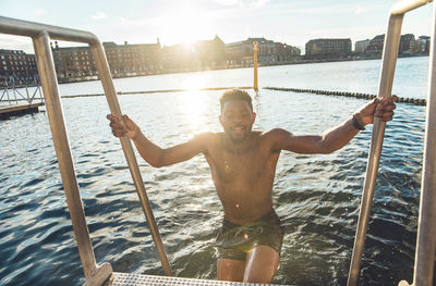 Portrait of man on railing against sea