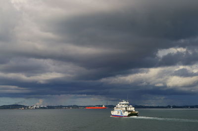 Boat sailing in sea against sky