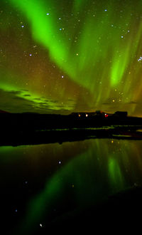 Scenic view of lake against sky at night