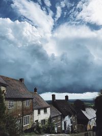 Low angle view of houses and buildings against sky
