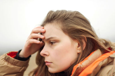 Close-up portrait of young woman looking away