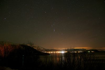 Scenic view of lake against sky at night
