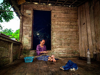 Woman sitting outside building