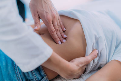 Pediatrician gastroenterologist doing abdominal examination to a preschooler boy