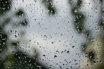 Full frame shot of wet glass window during rainy season