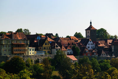 Residential buildings in town against clear sky