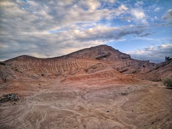 View of desert against cloudy sky