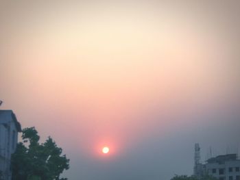 Scenic view of city against sky during sunset