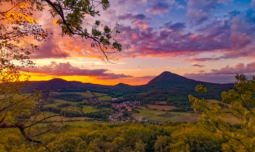 Scenic view of mountains against orange sky