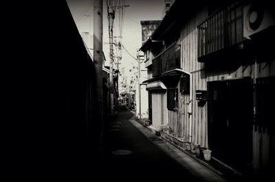 Empty road along buildings