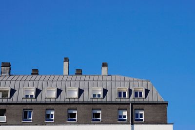 Low angle view of building against clear blue sky