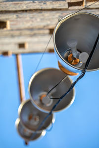 Low angle view of sunglasses against blue sky