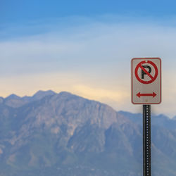 Road sign against sky during winter