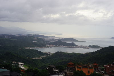 High angle view of townscape and mountains against sky