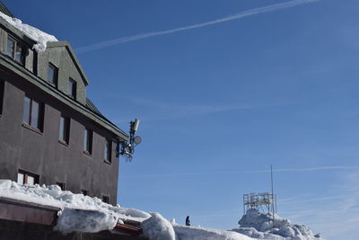 Low angle view of buildings against blue sky