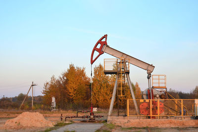 Traditional windmill on field against clear sky