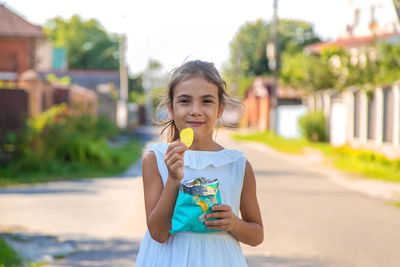 Portrait of girl eating potato chip