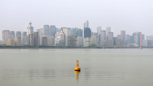 Modern buildings in city against clear sky