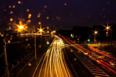 Light trails on bridge in city at night