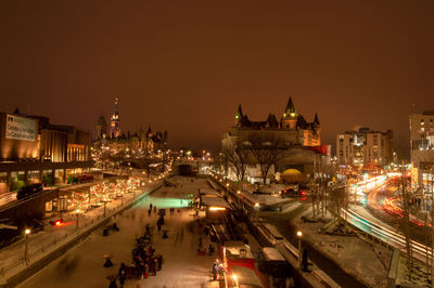 High angle view of traffic on road amidst buildings at night