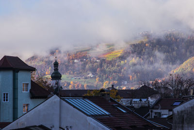 Smoke emitting from roof against sky