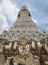 Low angle view of statue of temple against cloudy sky