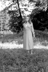 Portrait of woman standing on field