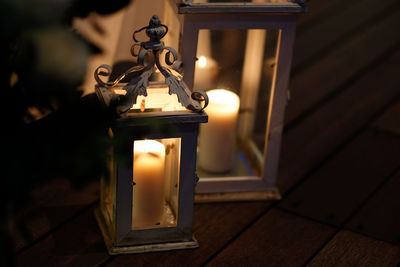 Close-up of illuminated lamp on table at home